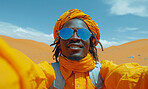 African man, desert and background with glasses  for travel, freedom or vacation. Health, activity and outdoors with selfie theme and sunset view for wellness, motivation or discovery in nature