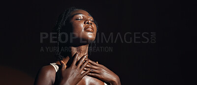 Face, hands and skincare with a natural black woman on a dark background in studio for feminine wellness. Arms, beauty and spa with a confident young model touching her body or skin in satisfaction