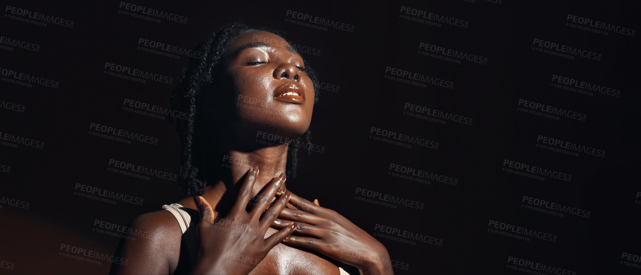 Buy stock photo Face, hands and skincare with a natural black woman on a dark background in studio for feminine wellness. Arms, beauty and spa with a confident young model touching her body or skin in satisfaction