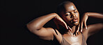 Face, hands and beauty with a natural black woman on a dark background in studio for feminine wellness. Arms, skincare and aesthetic with a confident model touching her body or skin in satisfaction