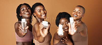 Happy black woman, skincare and beauty products for tone or foundation against a brown studio background. Group portrait of African female people or model smile together with skin makeup on mockup