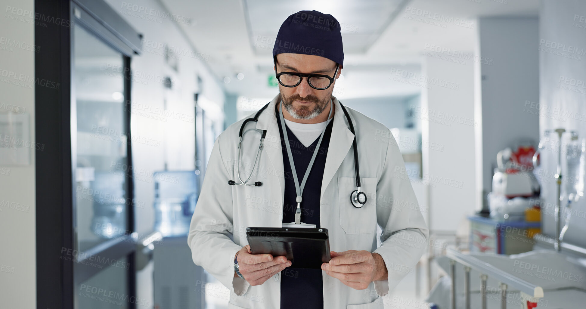 Buy stock photo Hospital, doctor and man with a tablet, typing and healthcare with email, consultant and website info. Mature person, employee and medical professional with technology, search internet and surgeon