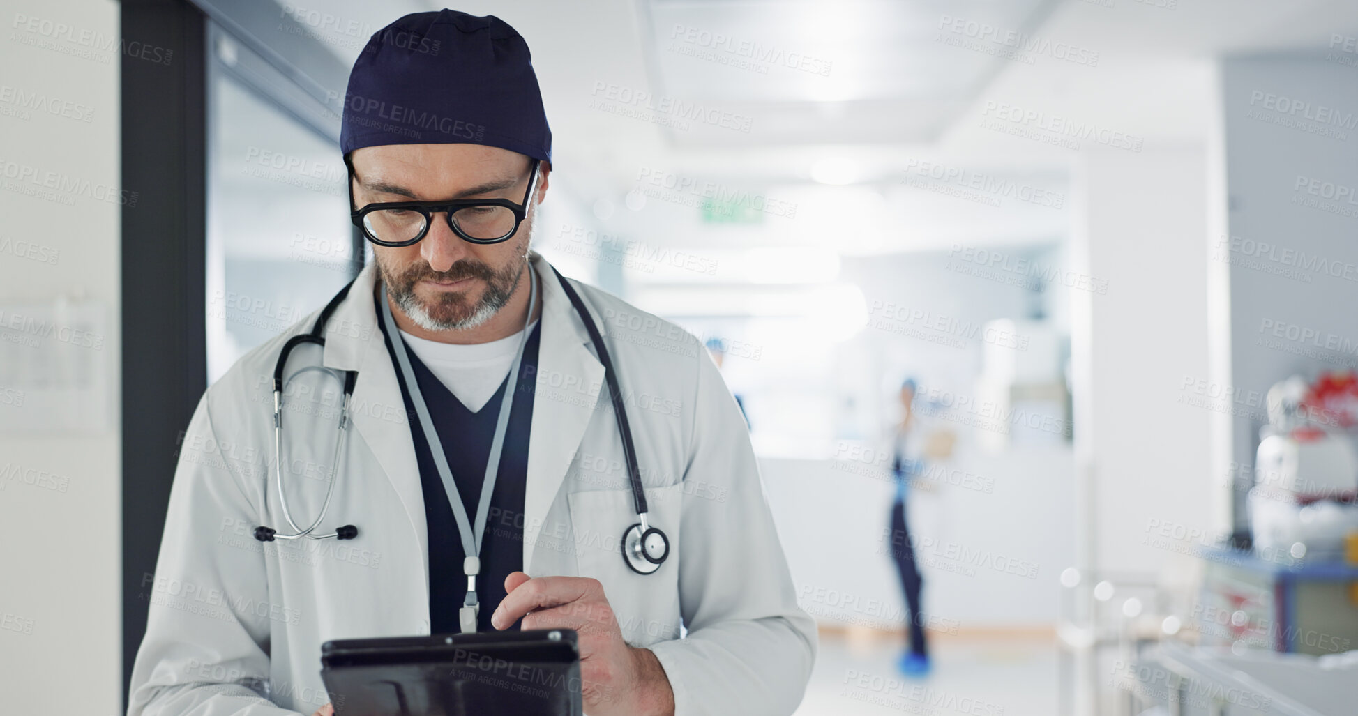 Buy stock photo Hospital, doctor and man with a tablet, typing and healthcare with email, consultant and website info. Mature person, employee and medical professional with technology, search internet and surgeon