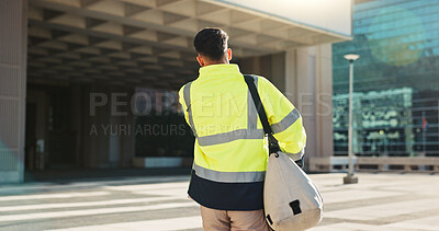 Man, back and architect walking in city for construction, maintenance or building at outdoor site. Rear view of male person, engineer or contractor carrying bag for project, architecture or plan
