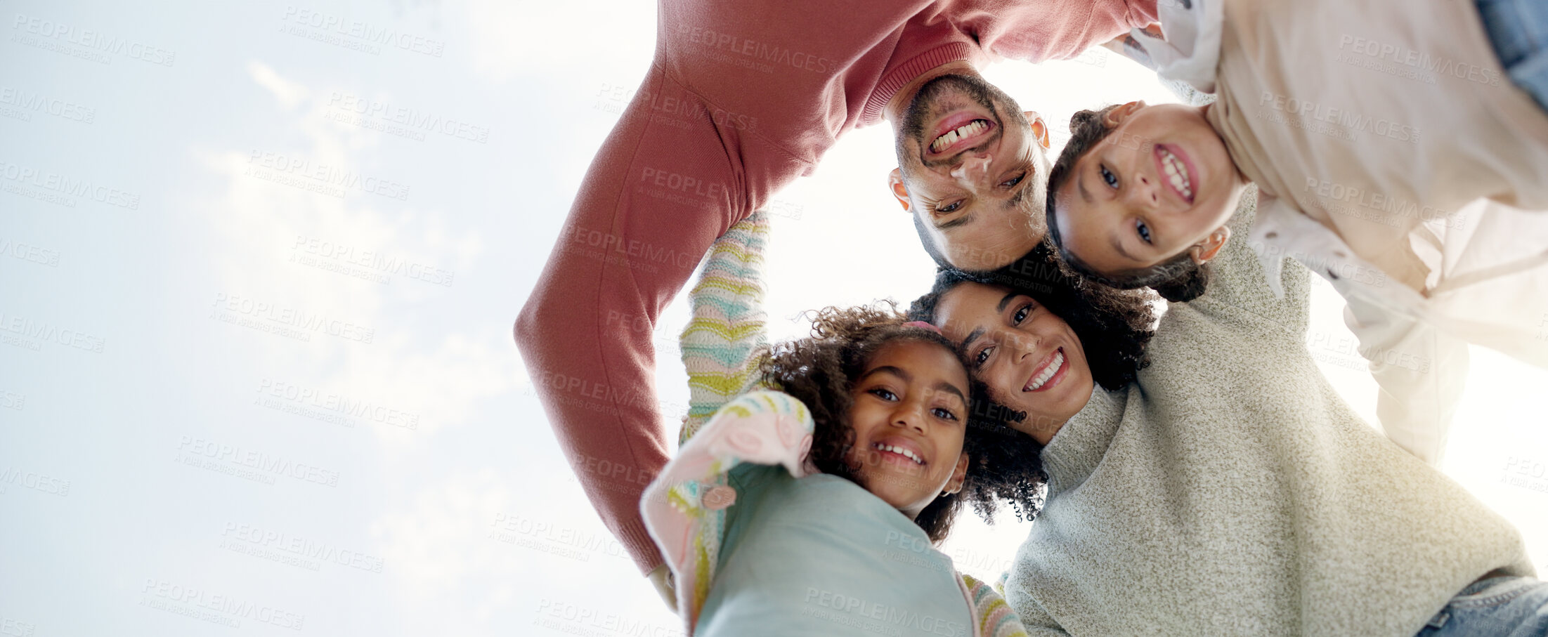 Buy stock photo Face, happy family and bottom hug outdoor for care, love or bonding on vacation, holiday and low angle. Smile, portrait of parents and children embrace together, having fun or enjoying quality time