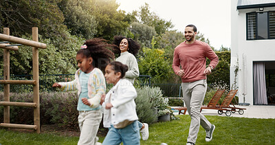 Family, running and children outdoor in backyard for playing, happiness and bonding at home. Young latino woman, man and happy kids at a playground while on holiday or vacation for a fun activity