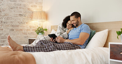 Couple, tablet and relax in home bedroom, laugh or morning with video, movie or meme for love, care or hug. Man, woman and digital touchscreen for typing, social network app or bond together in house