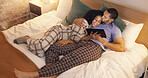 Couple, happy and hug in bedroom with tablet at night, streaming movie and relax. Smile, technology and man and woman in bed on social media app, watching online video and bonding together in home.