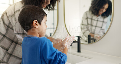 Happy woman, child and hands and washing in bathroom, cleaning to prevent germs and dirt in home with soap, water and mirror. Kid, mom and hand wash, teaching, learning and morning routine for family