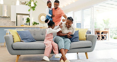 Happiness, playful parents and kids on sofa, black family having fun and smile in home together. Mother, father and young children playing on couch in living room, happy playing with love and support