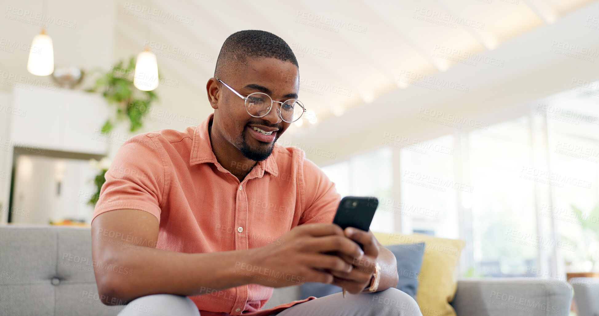 Buy stock photo Happy, typing and a black man with a phone on the sofa for social media, connection or communication. Smile, relax and an African person with a mobile for an app, email or notification in a house