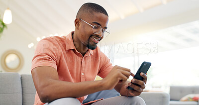 Happy, typing and a black man with a phone on the sofa for social media, connection or communication. Smile, relax and an African person with a mobile for an app, email or notification in a house