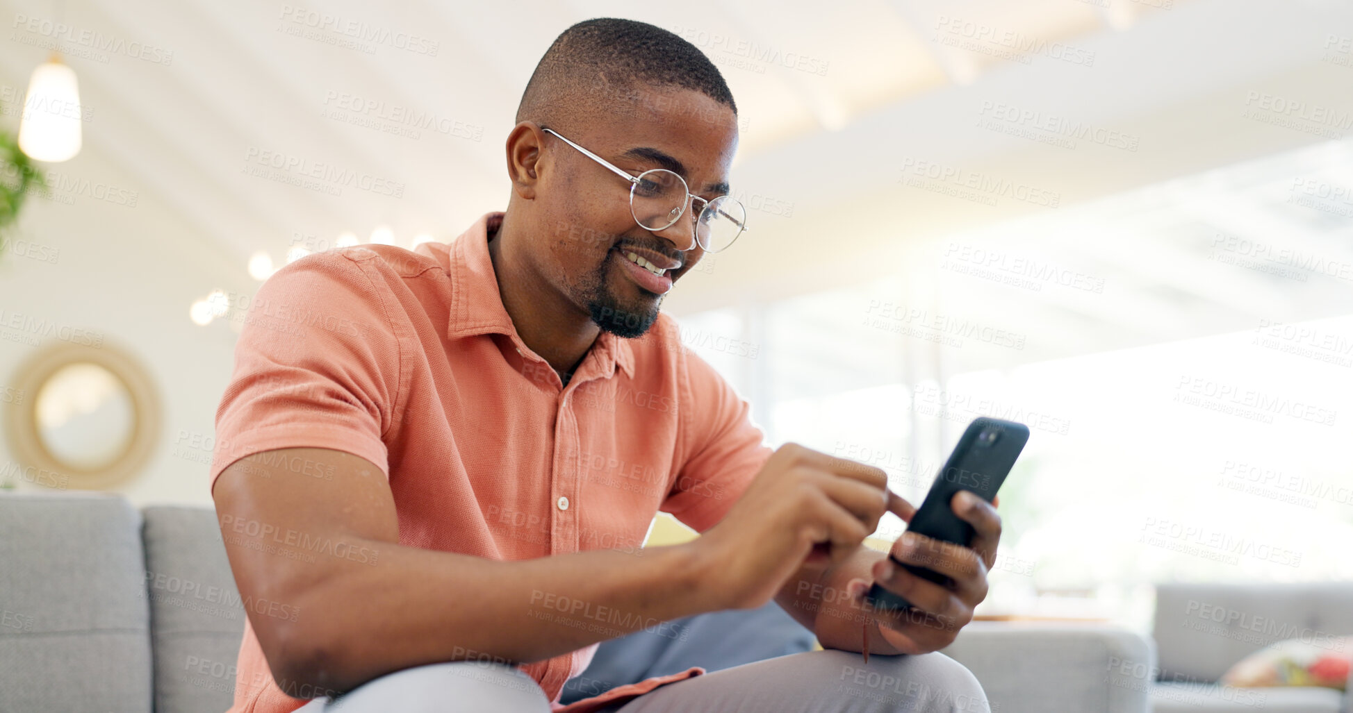 Buy stock photo Happy, typing and a black man with a phone on the sofa for social media, connection or communication. Smile, relax and an African person with a mobile for an app, email or notification in a house