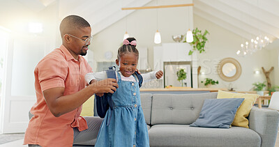 Black family, education and girl with backpack for school, kindergarten and high five from dad for support and motivation. Child, student and father helping to get ready and leave house in morning