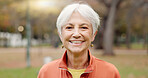 Senior woman with a smile, portrait in the park and happiness in nature, woods or outdoor for a walk in retirement. Happy, face and elderly person with wellness from exercise or healthy workout