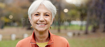 Senior woman with a smile, portrait in the park and happiness in nature, woods or outdoor for a walk in retirement. Happy, face and elderly person with wellness from exercise or healthy workout