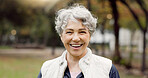 Portrait, senior woman and smile in the park with happiness in nature, woods or outdoor for a walk in retirement. Happy, face and elderly person with wellness from exercise or healthy workout