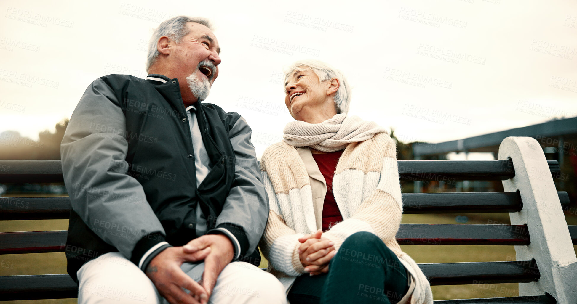 Buy stock photo Retirement, laugh and Senior couple on bench at park with happiness or bond for quality time. Love, happy face and  elderly woman or man in nature with support or embrace for trust or laugh together.