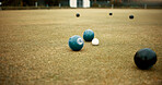 Green, balls and lawn bowling game on grass, field or pitch in a match or competition of outdoor bowls. Ball, moving and sport tournament at a bowlers club, league or championship games on the ground