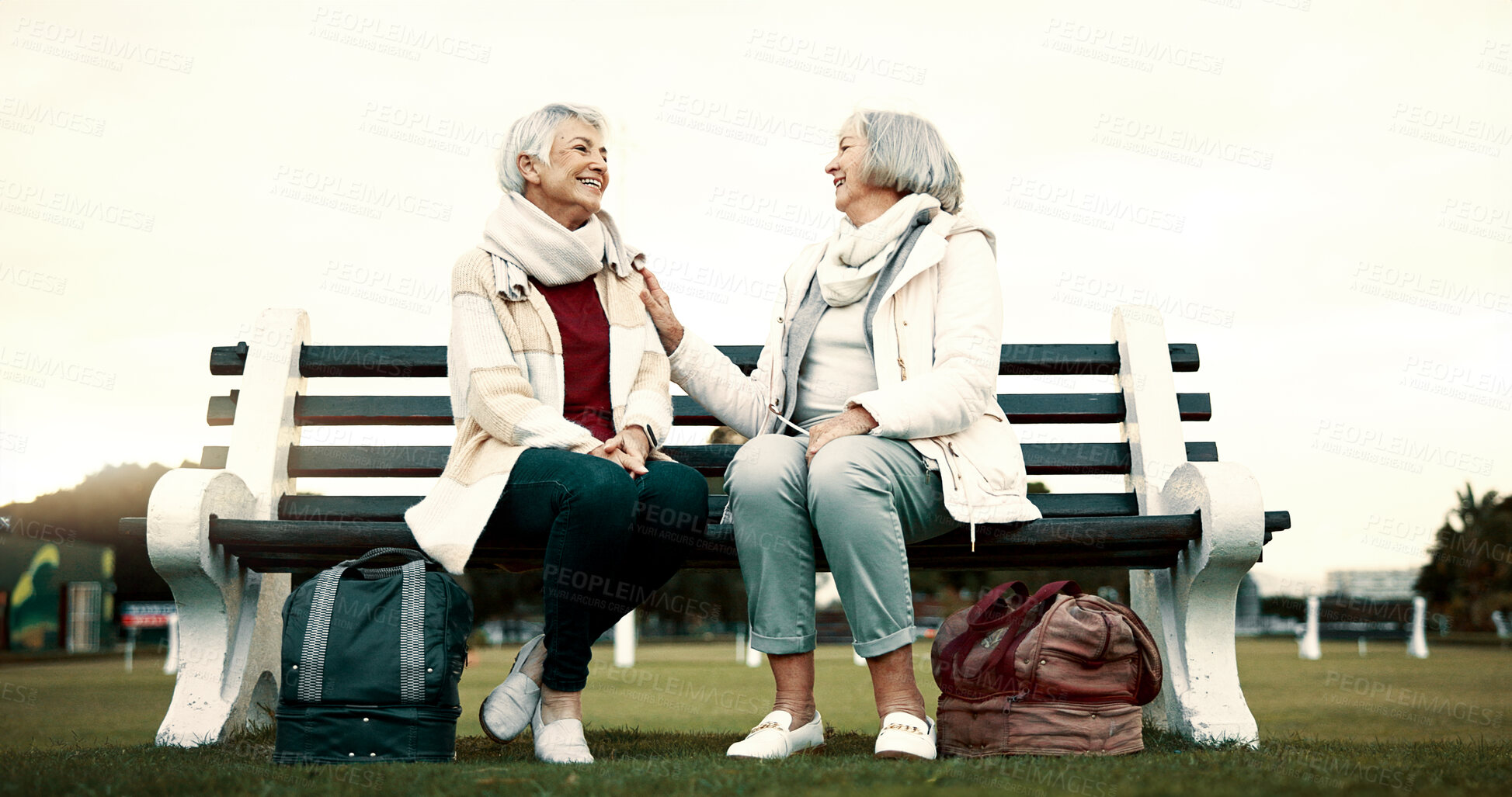 Buy stock photo Women, bench or old people talking in park or nature speaking or bonding together in retirement outdoors. Senior, elderly or mature woman in conversation to relax with peace or care on holiday break