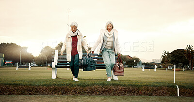 Retirement, hobby and senior woman friends walking on a field at the bowls club together for a leisure activity. Smile, talking and elderly people on the green of a course for bonding or recreation