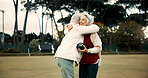 Bowling success, hug and women on a field with teamwork, support and celebration in sport. Happy, win and senior friends excited about a game or competition in a park for retirement hobby together
