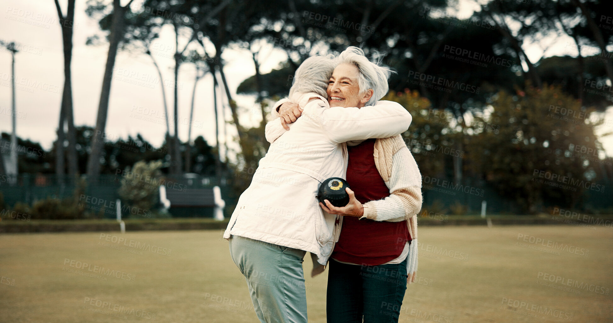 Buy stock photo Bowling success, hug and women on a field with teamwork, support and celebration in sport. Happy, win and senior friends excited about a game or competition in a park for retirement hobby together