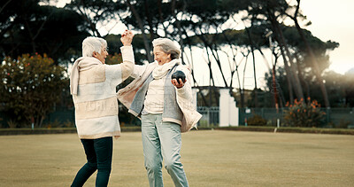 Senior women, high five and park for sport, lawn bowling and happy for fitness, goal and celebration in nature. Teamwork, elderly lady friends and metal ball for games, contest and winning together