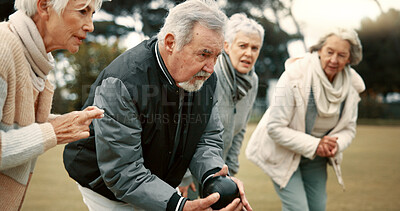 Senior man, game and senior people bowling in nature for retirement sports, teamwork and support. Bowling, friends and elderly man and woman in a group with a ball for a competition on a field together