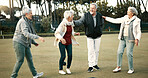 Bowls, celebration and hugging with senior friends outdoor, cheering together during a game. Motivation, support or applause and a group of elderly people clapping while having fun with a hobby