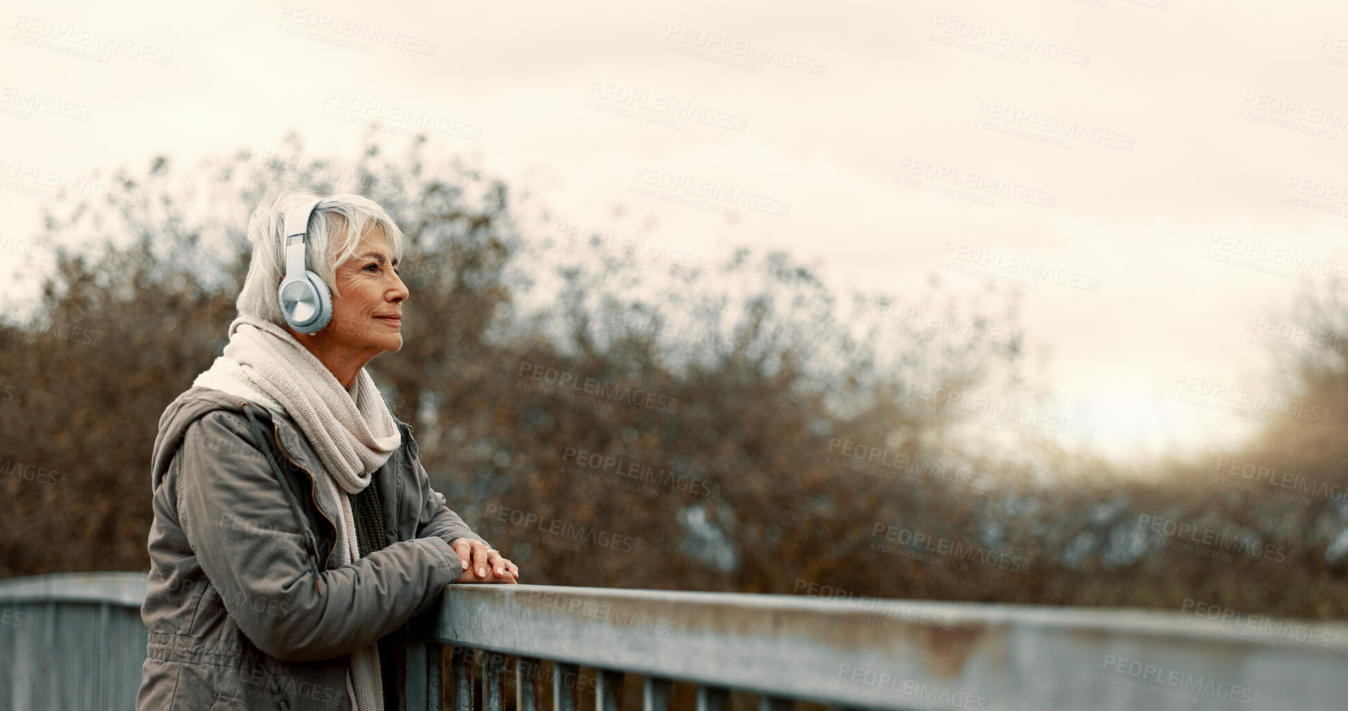 Buy stock photo Bridge, senior woman and headphones with music and thinking outdoor with view. Elderly female person, web radio and mockup space feeling relax in retirement with audio and freedom on calm holiday