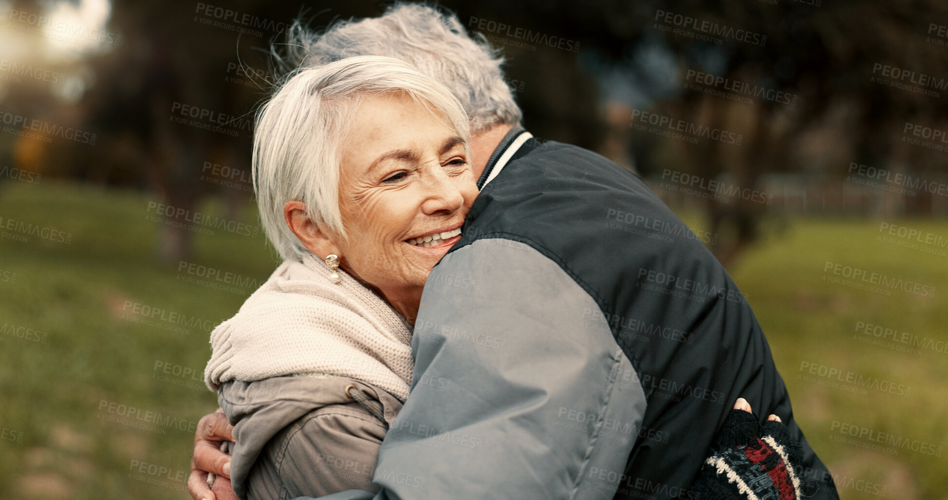 Buy stock photo Love, nature and smile with a senior couple hugging outdoor in a park together for a romantic date during retirement. Happy, support and an elderly man and woman bonding in a garden for romance