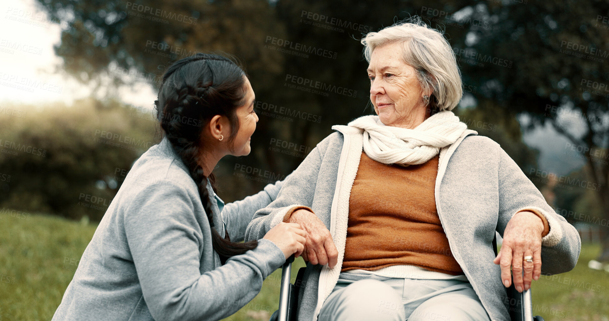 Buy stock photo Caregiver helping woman with disability in park for support, trust and care in retirement. Nurse talking to happy senior patient in wheelchair for rehabilitation, therapy and conversation in garden