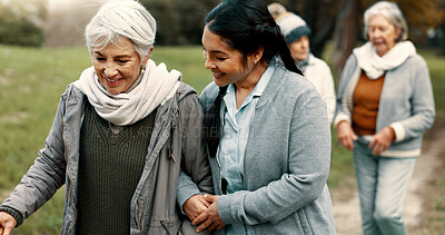 Happy, walking and a woman and caregiver in nature for talking, support and relax in the morning. Help, together and a young carer speaking to a senior patient in a park or garden for bonding