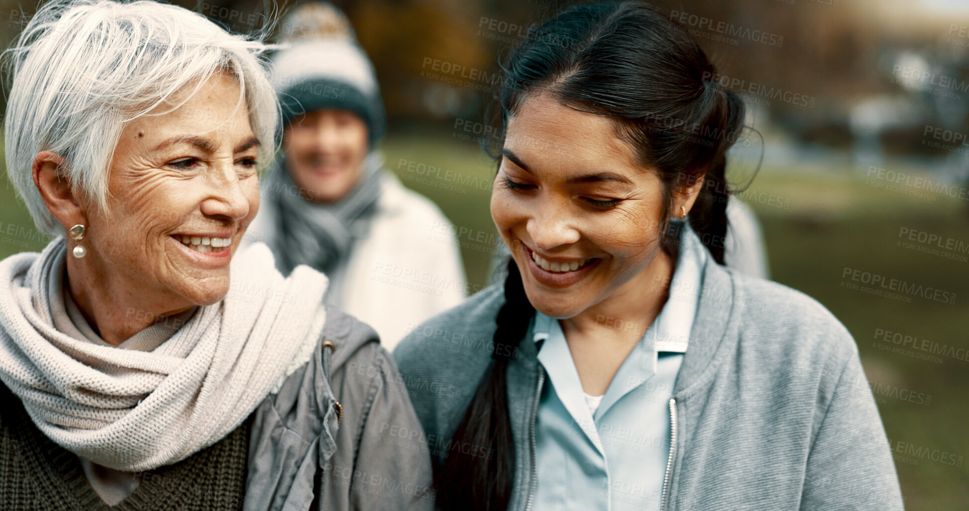 Buy stock photo Caregiver, team and senior friends walking outdoor of a nursing home talking in a conversation for support and trust. Care, speaking and nurse exercise with elderly people for wellness and health