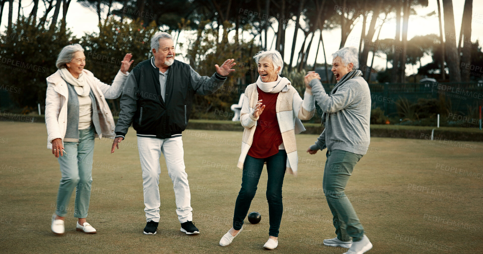 Buy stock photo Bowls, celebration and hugging with senior friends outdoor, cheering together during a game. Motivation, support or applause and a group of elderly people clapping while having fun with a hobby
