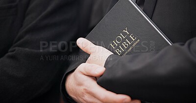 Bible, funeral and hands closeup of a priest for religion, sad and mourning event in church. Faith, male person and spiritual passage with worship and book for grief with support and condolences