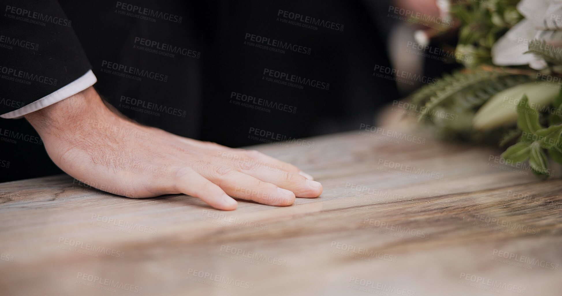 Buy stock photo Death, funeral and hand of man on coffin, family at service in graveyard or church for respect. Flowers, loss and people at wood casket in cemetery with memory, grief and sadness at grave for burial.