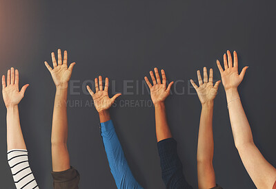 Buy stock photo Shot of a group unrecognizable people holding up their hands inside of a building