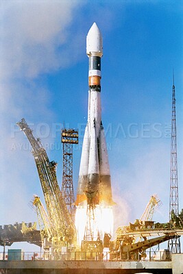 Buy stock photo Rocket launch into sky, travel and space mission for research, exploration and discovery in cosmos. Science, aerospace innovation or technology, spaceship in flight at ground site with flame and fuel