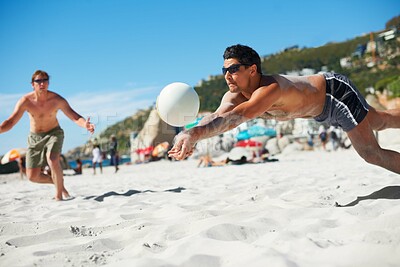 Buy stock photo Shot of a beach volleyball game on a sunny day