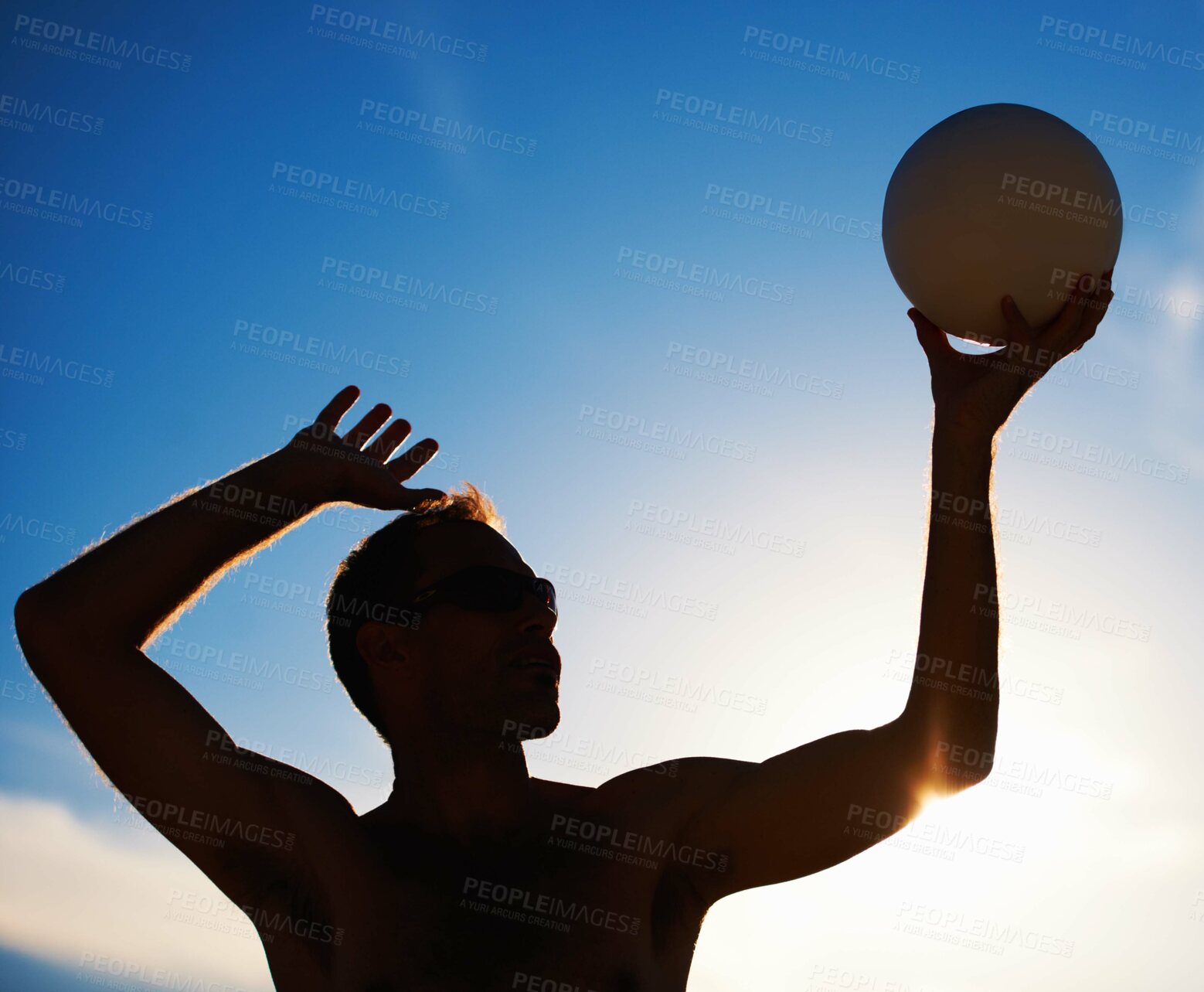 Buy stock photo Volleyball, training and fitness man with ball serve, energy or freedom on blue sky background. Seaside, sport or male player with handball in nature for cardio, workout or athletic game performance

