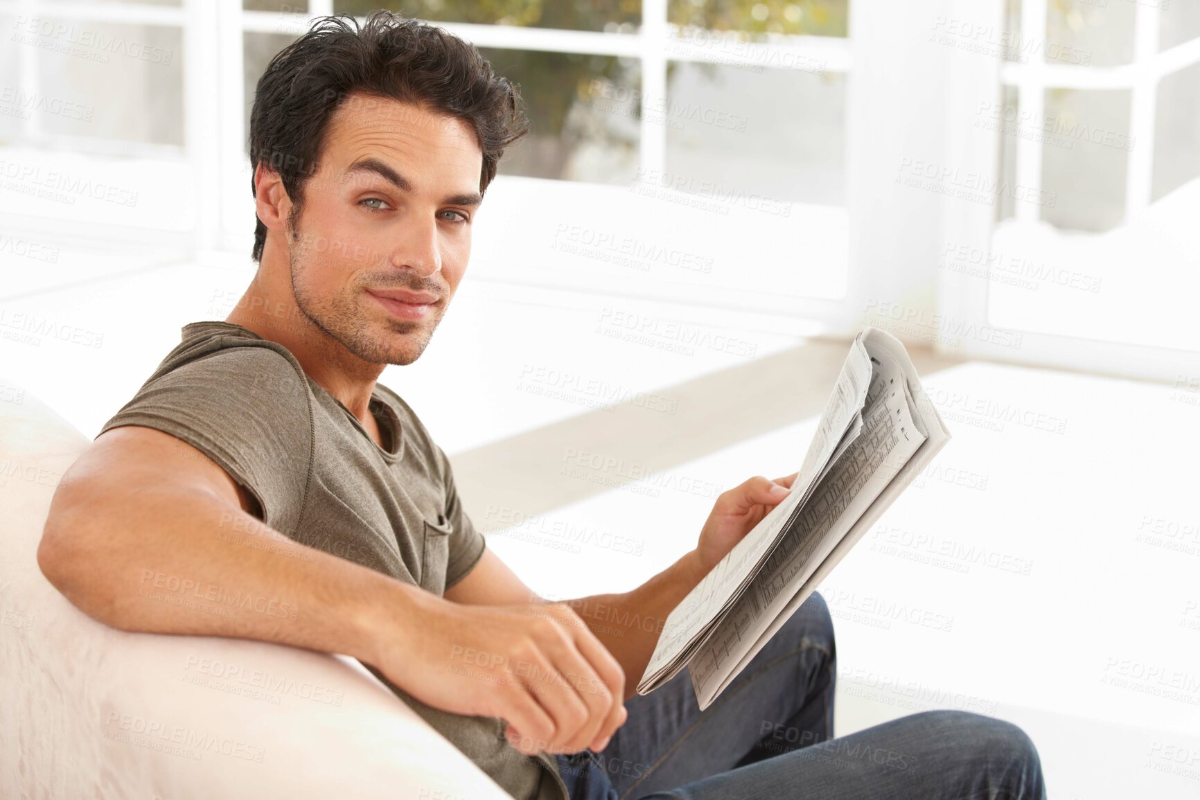 Buy stock photo Man, portrait and smile with newspaper on sofa for relax, morning break and information in living room. Person, face and happy for article, story and news on couch of apartment for reading or peace  