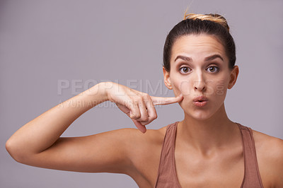 Buy stock photo Portrait, beauty and finger on cheek with woman in studio on gray background for dermatology or cosmetics. Face, skincare and spa with natural young person pointing to mouth for wellness or facial