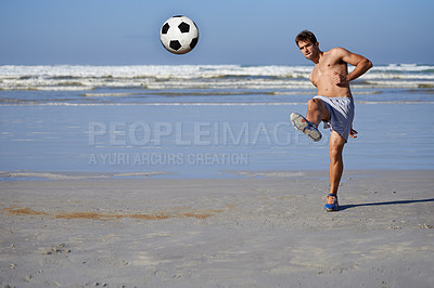 Buy stock photo Man, beach and soccer ball in fitness, exercise or outdoor hobby for surfing or practice. Young male person or sports player kicking on ocean coast for football game, match or friendly by the seaside