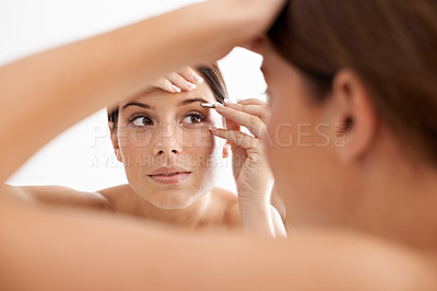 Buy stock photo Beauty, mirror reflection and woman face for eyebrow maintenance, hair removal or cosmetic routine. Bathroom, tweezers and studio person grooming with facial plucking tools on white background