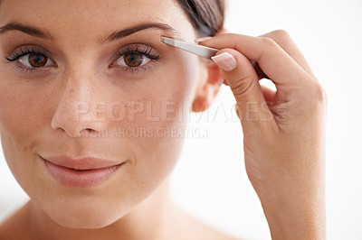 Buy stock photo Woman, portrait and plucking eyebrow with tweezers for beauty and self care in bathroom. Makeup, routine and girl with hair removal, tools and facial grooming or cleaning for skincare and cosmetics