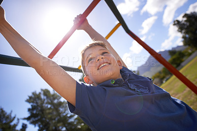 Buy stock photo Child, monkey bars and energy on playground, smiling and obstacle course on outdoor adventure at park. Happy male person, active and exercise on jungle gym, boy and fitness on vacation or holiday