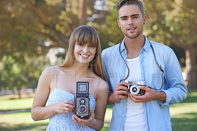 Buy stock photo Portrait, park and happy couple of friends with vintage camera for outdoor photography, photo memory or tourism. Retro equipment, creative photographer and people smile for spring picture in nature
