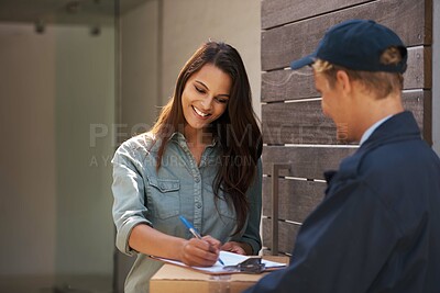 Buy stock photo Shot of a young woman signing for a delivery
